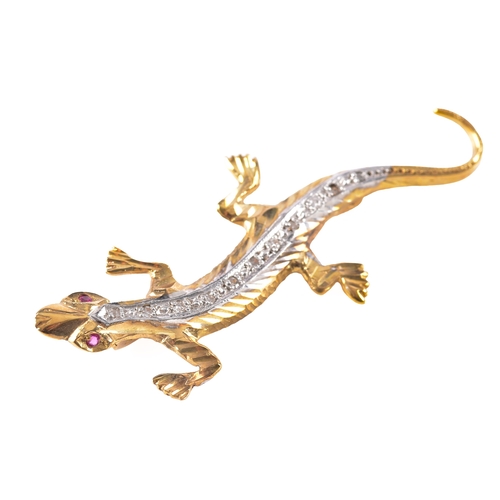 32 - A Gold and Diamond Lizard Brooch, featurng a diamond set spin, ruby eyes and a patterned tail, fitte... 