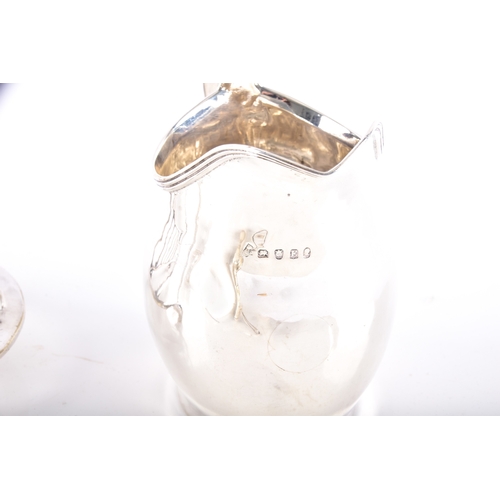 197 - A George V silver creamer hallmarked for Birmingham 1912 by T H Hazlewood & Co, 6.5 cm high, a G... 