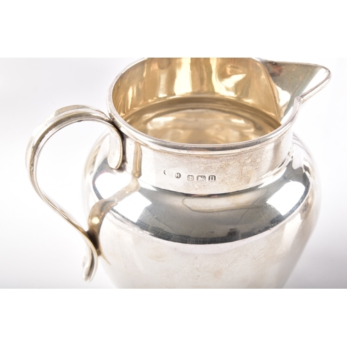 197 - A George V silver creamer hallmarked for Birmingham 1912 by T H Hazlewood & Co, 6.5 cm high, a G... 
