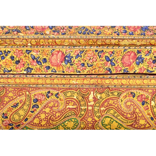 345 - A 19th century Persian papier-mache stationery box, of elongated octagonal form, the hinged cover ri... 
