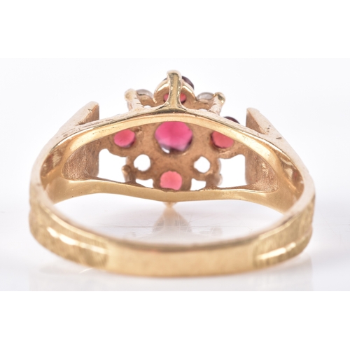 8 - Two 9ct yellow gold rings, including a garnet and paste floral cluster hallmarked for London 1977, s... 