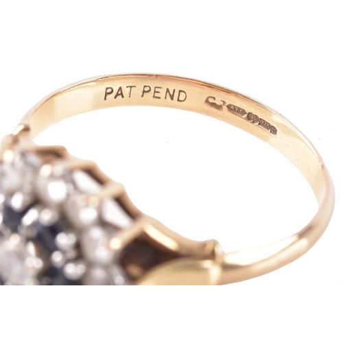 15 - A 9ct yellow gold sapphire and white stone floral cluster ring, leading to raised leaf motif shoulde... 