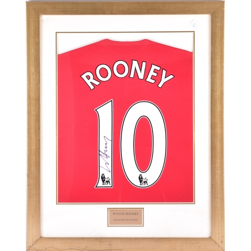 350 - A framed Manchester United red home shirt, the reverse printed 'Rooney' and numbered 10, signed in b... 