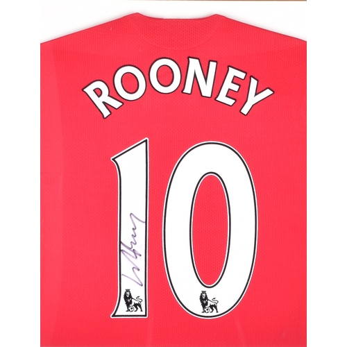 350 - A framed Manchester United red home shirt, the reverse printed 'Rooney' and numbered 10, signed in b... 