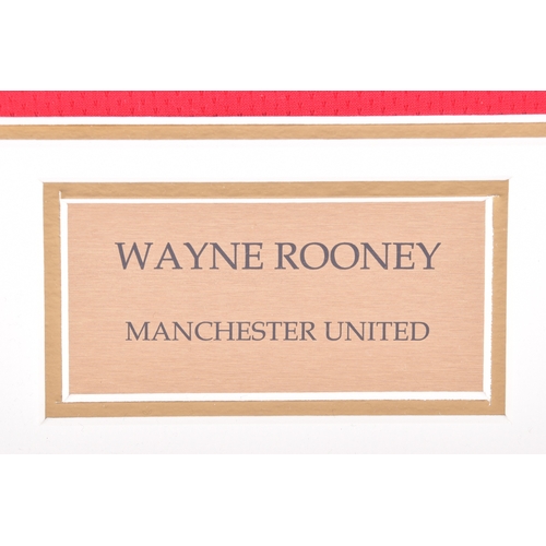 350 - A framed Manchester United red home shirt, the reverse printed 'Rooney' and numbered 10, signed in b... 