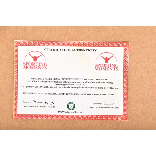 350 - A framed Manchester United red home shirt, the reverse printed 'Rooney' and numbered 10, signed in b... 