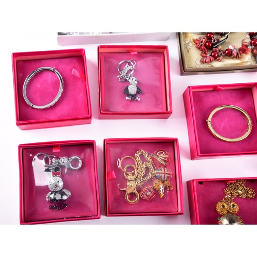 71 - A large collection of Butler & Wilson pieces, including three bangles, four key rings, a owl nec... 