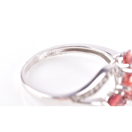 54 - A 9ct yellow gold and pink tourmaline ring, with stepped shoulders inset with white stone accents, s... 