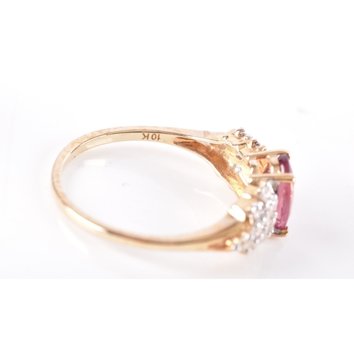 54 - A 9ct yellow gold and pink tourmaline ring, with stepped shoulders inset with white stone accents, s... 