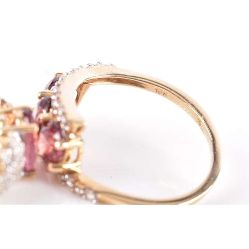54 - A 9ct yellow gold and pink tourmaline ring, with stepped shoulders inset with white stone accents, s... 
