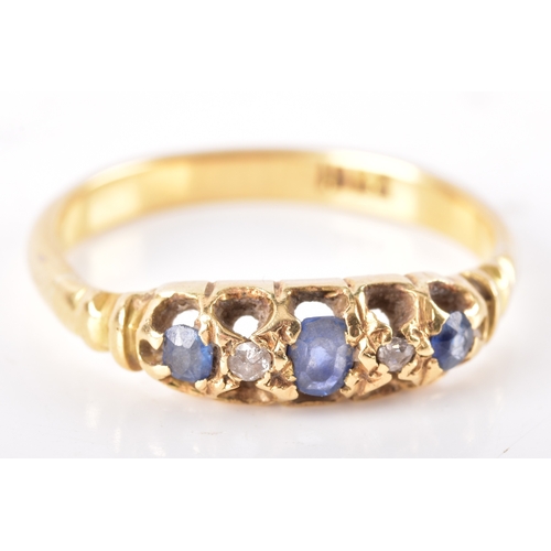 22 - An 18ct yellow gold, sapphire, and diamond ring, claw-set with three mixed-cut sapphires, and two di... 