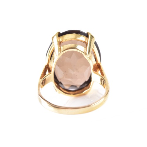 8 - A 9ct yellow gold smoky quartz dress ring, quartz measuring approximately 20 x 15 mm, hallmarked for... 