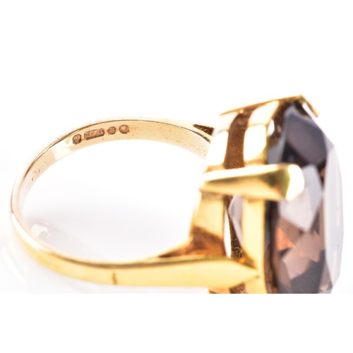 8 - A 9ct yellow gold smoky quartz dress ring, quartz measuring approximately 20 x 15 mm, hallmarked for... 