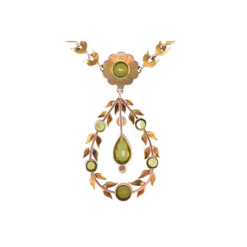 11 - A late 19th/early 20th century 9ct gold peridot and seed pearl necklace, of openwork foliate and gar... 