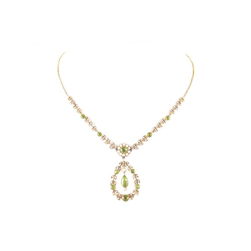 11 - A late 19th/early 20th century 9ct gold peridot and seed pearl necklace, of openwork foliate and gar... 