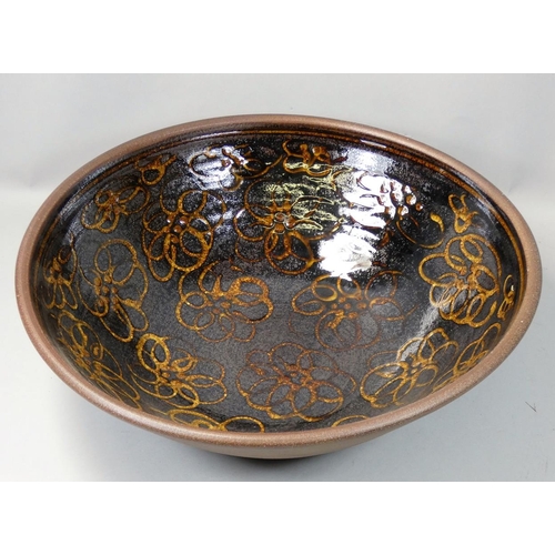 105 - Peter Dick (1936 - 2012), a large earthenware bowl for Coxwold Pottery, over glazed flower decoratio... 