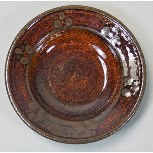 108 - Peter Dick (1936 - 2012), a small glazed dish, impressed mark to the base, diameter 15.5cm.