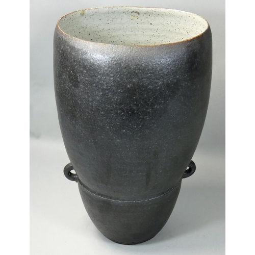 148 - David Lloyd-Jones (1928 - 1994), a twin handled vase with a speckled ebony glaze, mottled cream inte... 