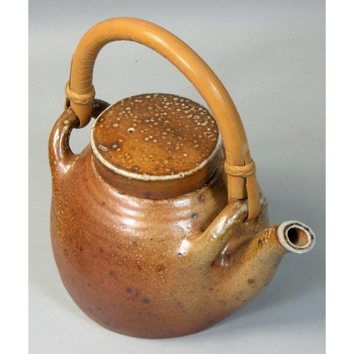 187 - Sarah Walton (b.1945), an ochre glazed stoneware teapot, with speckle pattern design, bamboo handle,... 