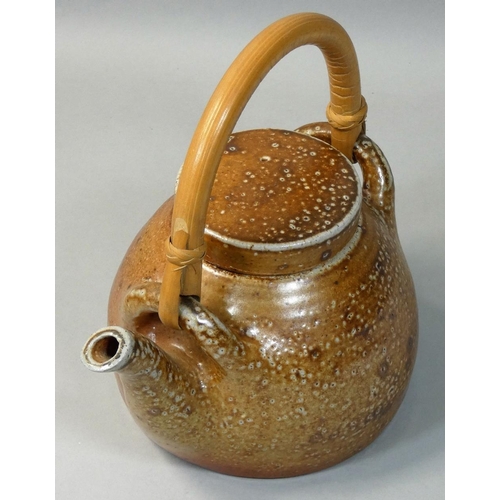 187 - Sarah Walton (b.1945), an ochre glazed stoneware teapot, with speckle pattern design, bamboo handle,... 