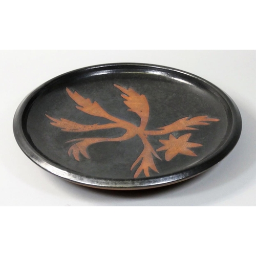 24 - Harry Horlock-Stringer (1927-2014), an ebonised dish with inset floral pattern motif, Barnes, dated ... 