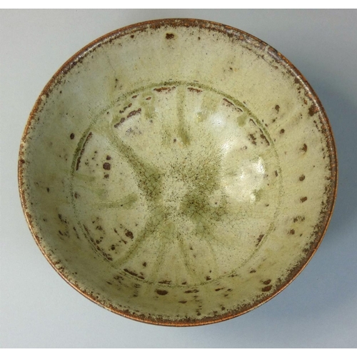 28 - Richard Batterham (b.1936), a porcelain bowl with green ash glaze, raised on a small conical foot, D... 