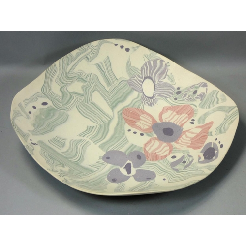 43 - Margery Clinton, a stoneware dish of irregular square form, painted with flowers and abstract patter... 