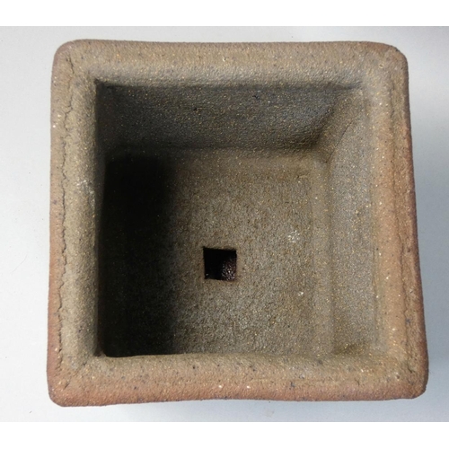 45 - A stoneware planter with water reservoir, of square form with applied decoration, height 15cm.