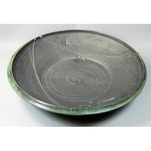 73 - Charles Bound (b.1939), a large stoneware abstract pattern dish, spiral pattern to the centre, diame... 