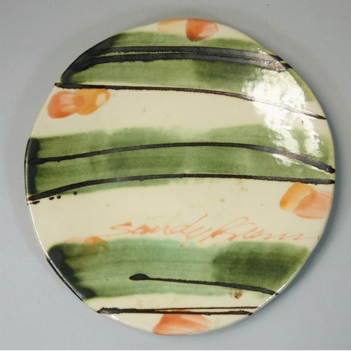 83 - Sandy Brown (b.1946), a circular plate with bold brushwork and trailed decoration, signed to the fac... 