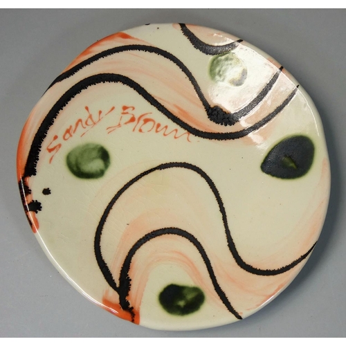 85 - Sandy Brown (b.1946), a circular plate with bold brushwork and trailed decoration, signed to the fac... 