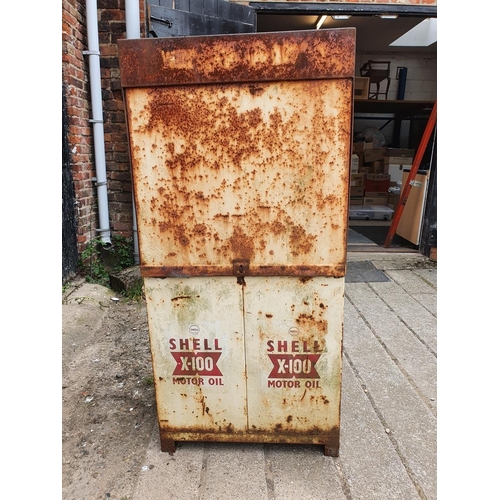 73 - A vintage oil dispenser cabinet, painted in white with Shell X 100 oil markings, the sliding door op... 