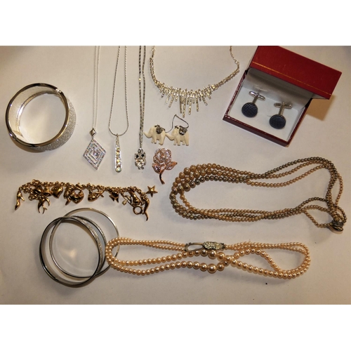 100 - A quantity of costume jewellery to include a gilt metal charm bracelet.