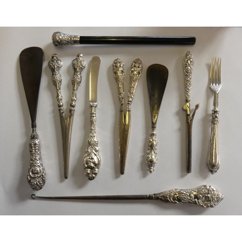 101 - An Edwardian silver handled crimper, Chester 1902, two pairs of silver handled glove stretches, Birm... 