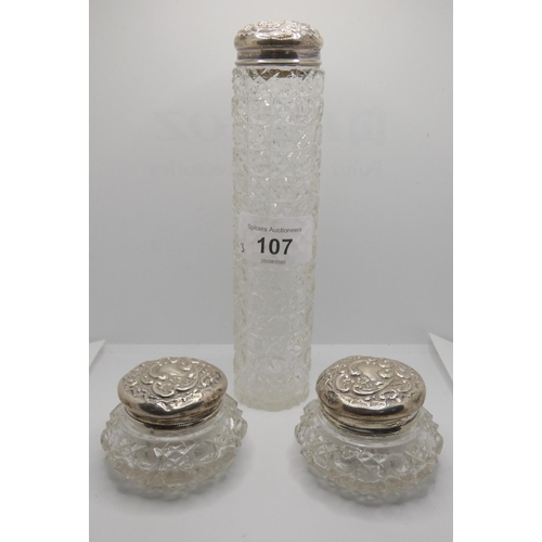 107 - A silver pair of lidded cut glass trinket dishes, Birmingham 1905 and another silver lidded holder (... 