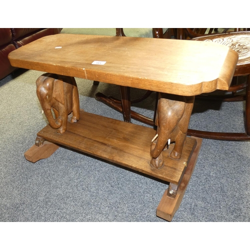 181 - An oak 'Elephant table' 65 cm wide x 29 cm deep, the shaped top over supports in the form of elephan... 
