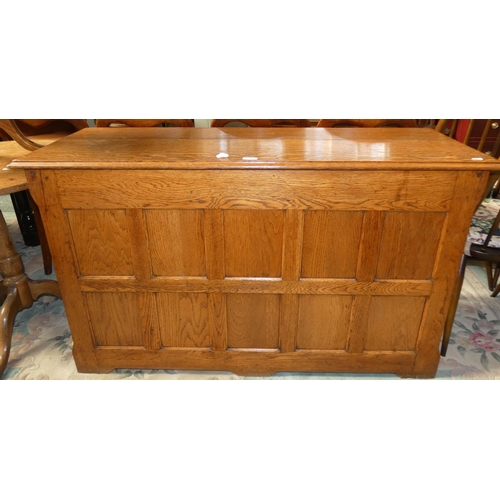 182 - A panelled oak coffer 128 cm wide x 76 cm tall x 47 cm deep, together with an oak circular tilt top ... 