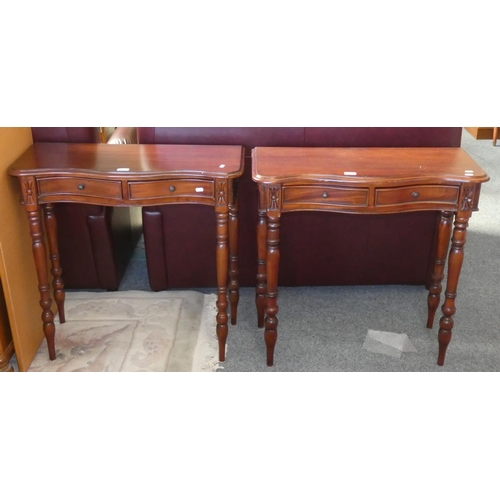 191 - A pair of mahogany serpentine twin drawer side tables each 79 cm wide.