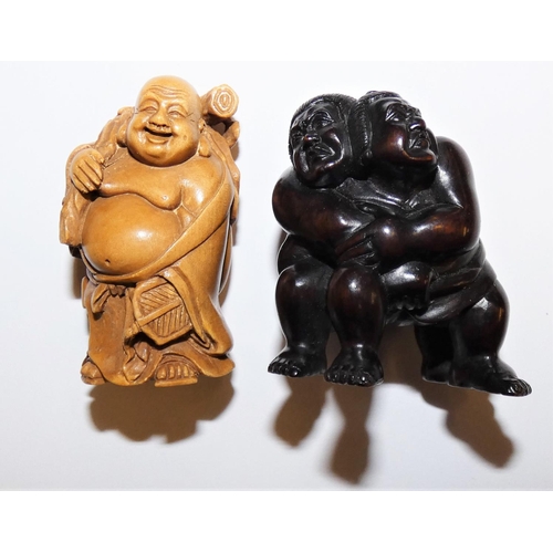 150 - A Japanese carved hardwood netsuke, in the form of Sumo wrestlers, inset signature, height 5 cm and ... 