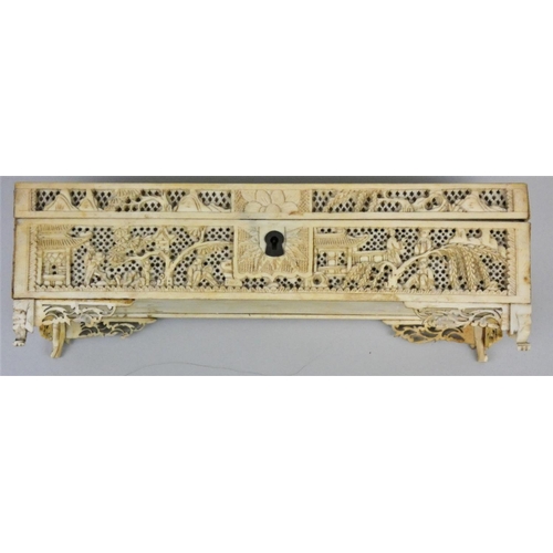 160 - A Cantonese 19th century carved and pierced ivory casket, the hinged cover with people in temples an... 