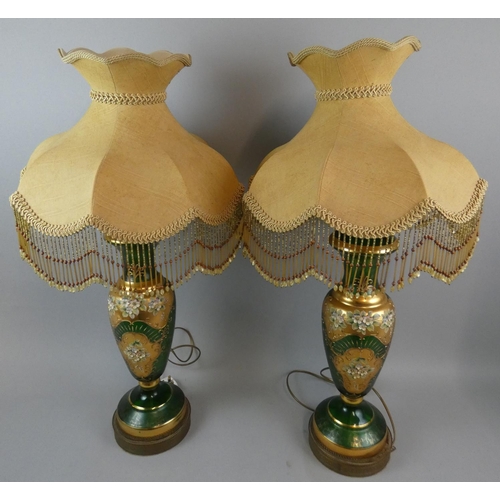 170 - A pair of large Victorian glass table lamps, of baluster form, the emerald green ground with gilt sc... 