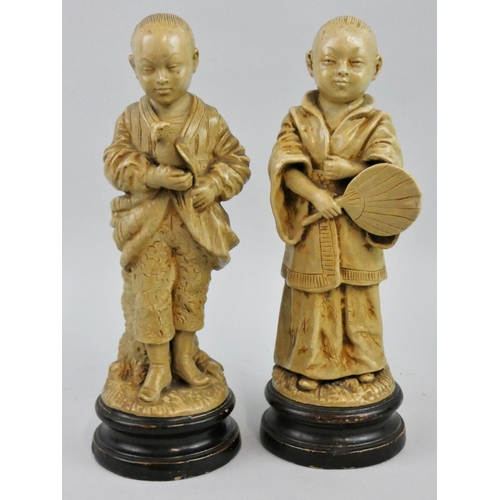 180 - A 19th century pair of Bohemian pottery spill vases in the form of a Chinese boy and girl, by Bernha... 