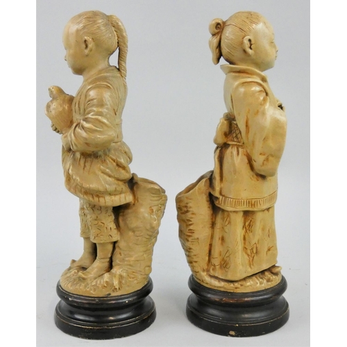 180 - A 19th century pair of Bohemian pottery spill vases in the form of a Chinese boy and girl, by Bernha... 