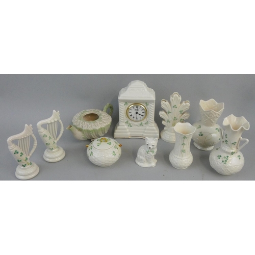 184 - A collection of 'Shamrock' pattern Belleek ware, various dates, to include; a mantle clock, two-hand... 