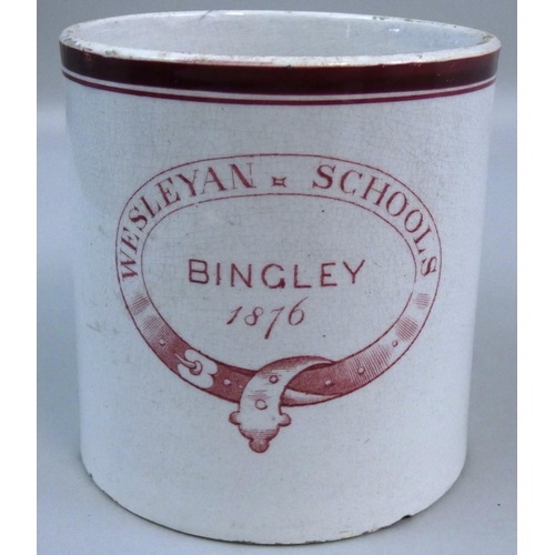 185 - A 19th century commemorative mug printed on one side with the Rev. John Wesley, on the other side wi... 