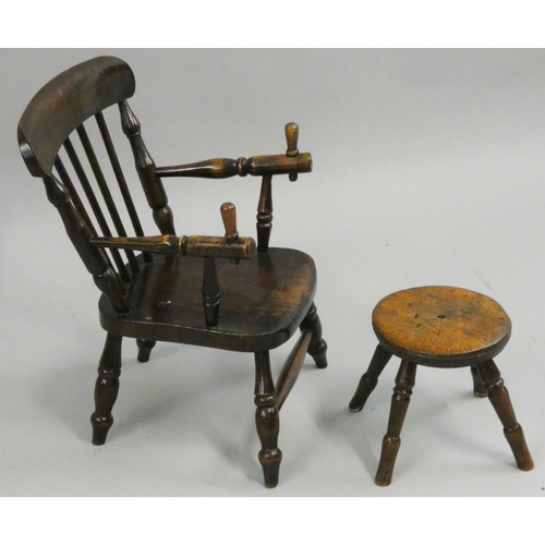 373 - A 19th century fruitwood child's chair with spindle band, screw pegs to the arms, lacking retaining ... 