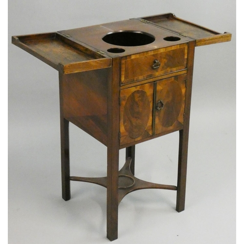 398 - A Georgian mahogany night stand, the hinged lid opening to reveal three wells over a pair of cupboar... 