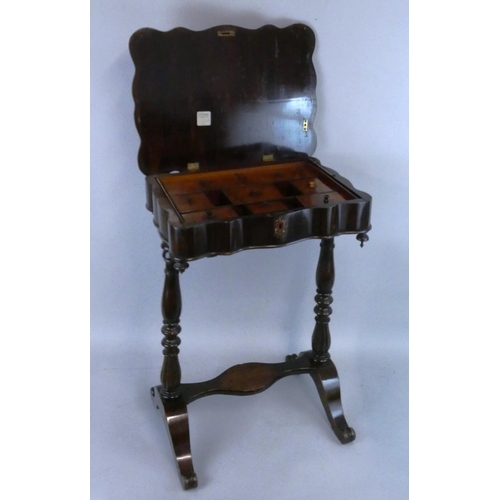 409 - A Victorian mahogany work table, the shaped top opening to reveal a fitted interior with lidded comp... 