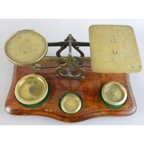 136 - A Victorian set of brass and mahogany postal scales, the plate inscribed with weights and prices, an... 