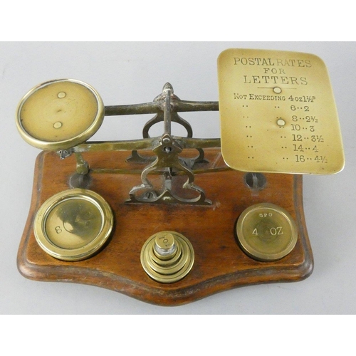 136 - A Victorian set of brass and mahogany postal scales, the plate inscribed with weights and prices, an... 